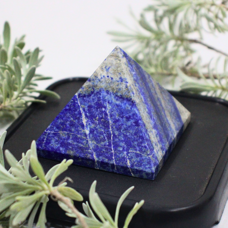 Raw Lapis Lazuli Pyramid Raw lapis lazuli pyramid with deep blue tones and golden pyrite flecks for wisdom and focus.