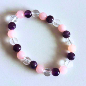 Relationship healing bracelet made with rose quartz, amethyst, and clear quartz crystals for love and emotional balance.