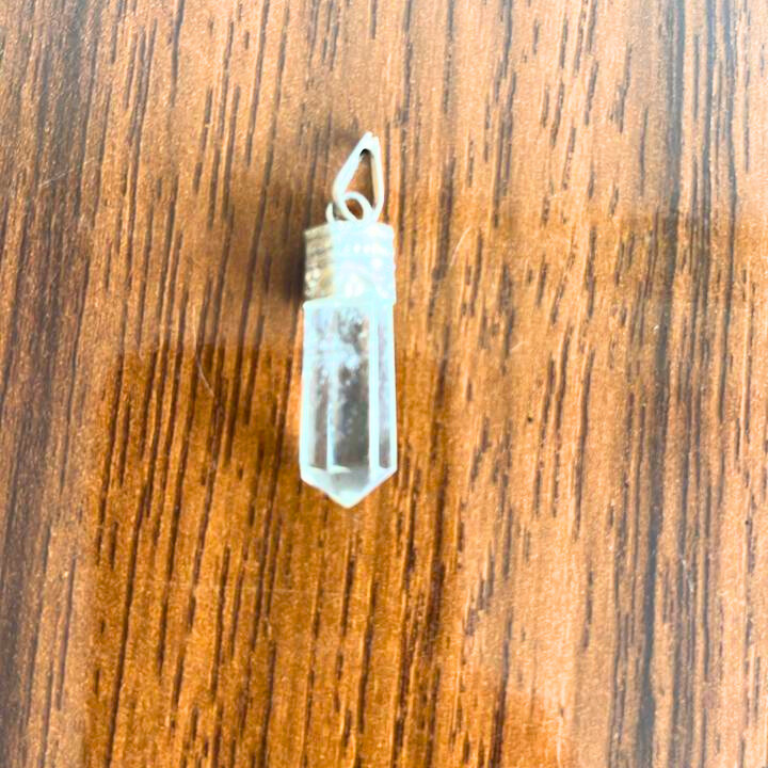 Clear Quartz Metal Cap Pendant Clear quartz crystal pendant with a metal cap and transparent polished stone.