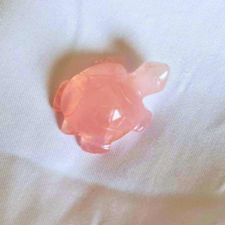 Rose Quartz Crystal Tortoise Rose quartz crystal tortoise with a smooth polished finish and soft pink color.