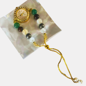 Handcrafted Money Magnet Crystal Watch with natural prosperity crystals and a premium golden adjustable chain. Wear it as a watch charm, bracelet, or Rakhi.