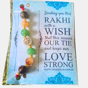 Handcrafted Money Magnet Rakhi featuring Tiger Eye, Natural Citrine, Green Aventurine, Pyrite, and Golden Hematite crystals for prosperity, confidence, balance, and positive energy.