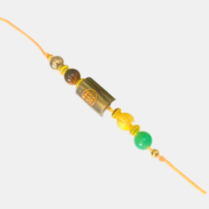 Handcrafted Money Magnet Rakhi featuring a natural Pyrite crystal and a Zibu Coin, symbolizing prosperity, abundance, confidence, success, and positive energy.