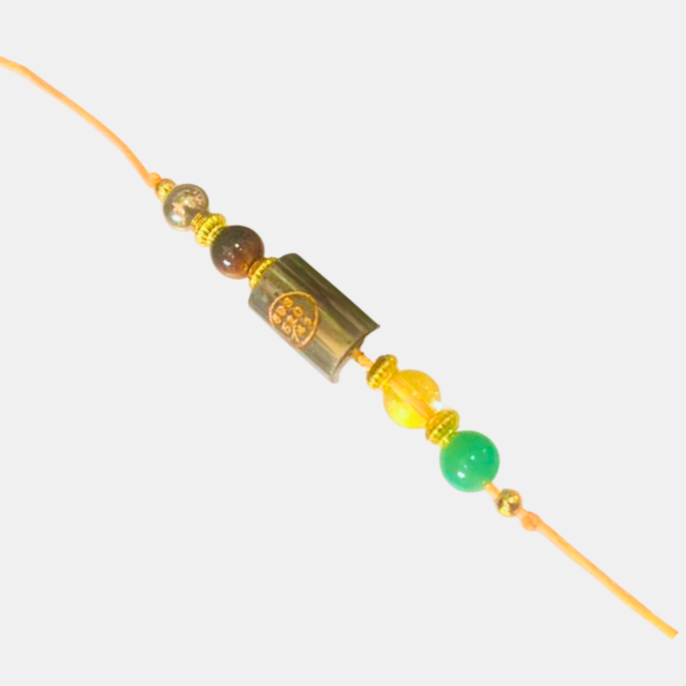 _Money Magnet Rakhi With Pyrite Zibu Coin Handcrafted Money Magnet Rakhi featuring a natural Pyrite crystal and a Zibu Coin, symbolizing prosperity, abundance, confidence, success, and positive energy.