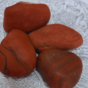 Natural Raw Red Jasper crystal with an unpolished finish, valued for grounding, strength, stability, courage, and emotional balance.
