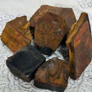 Natural Raw Tiger Eye crystal with an unpolished finish, valued for confidence, courage, focus, determination, emotional balance, and grounding.